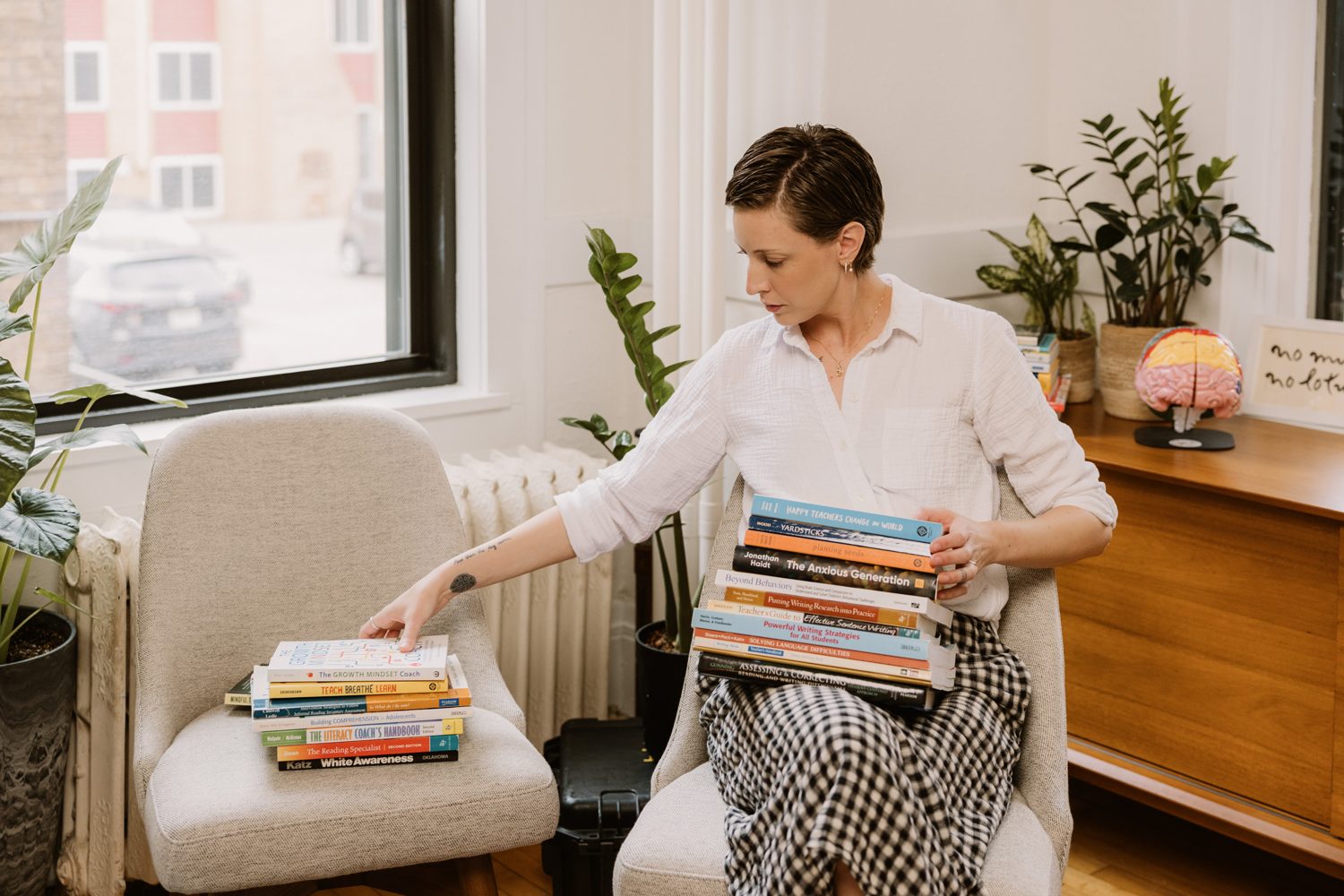 Book stacks arranged across two chairs