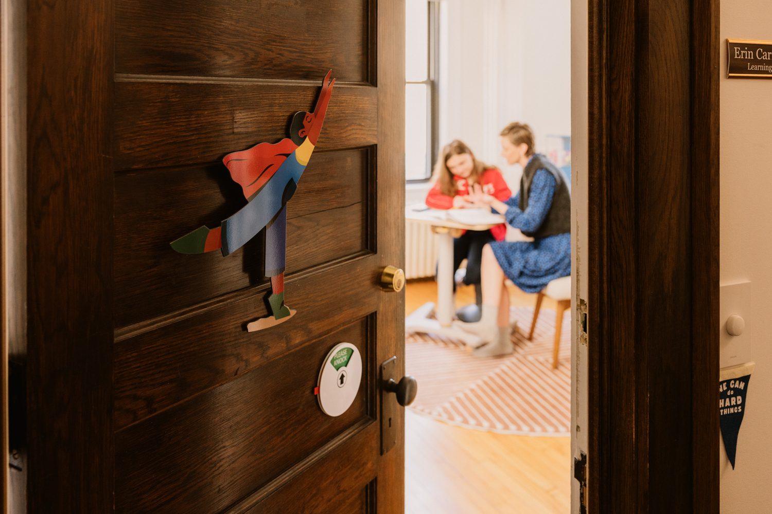 The office door standing open, a paper superhero mid-flight